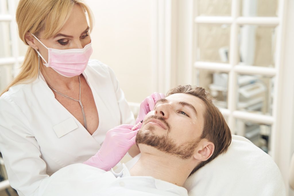 Collected patient experiencing botox treatment in beauty clinic
