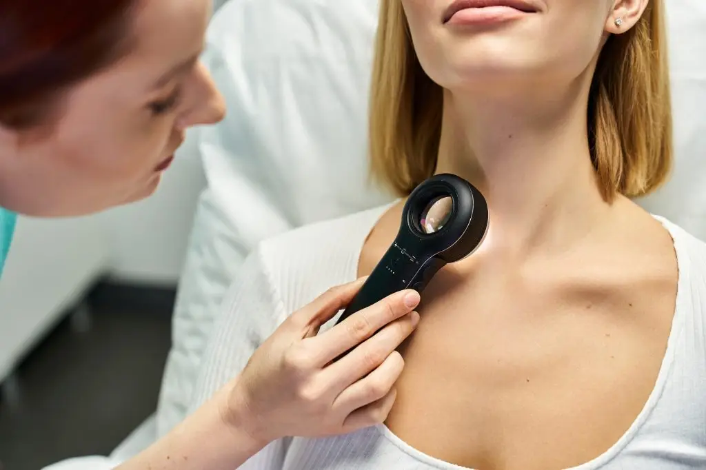 Expert dermatology consultation highlighting procedure for skin analysis on young woman