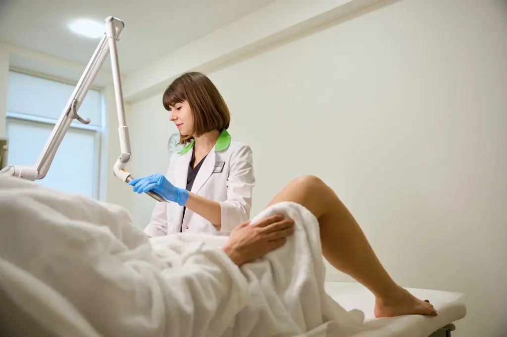 Female gynecologist performs modern procedure for laser treatment of vaginal walls