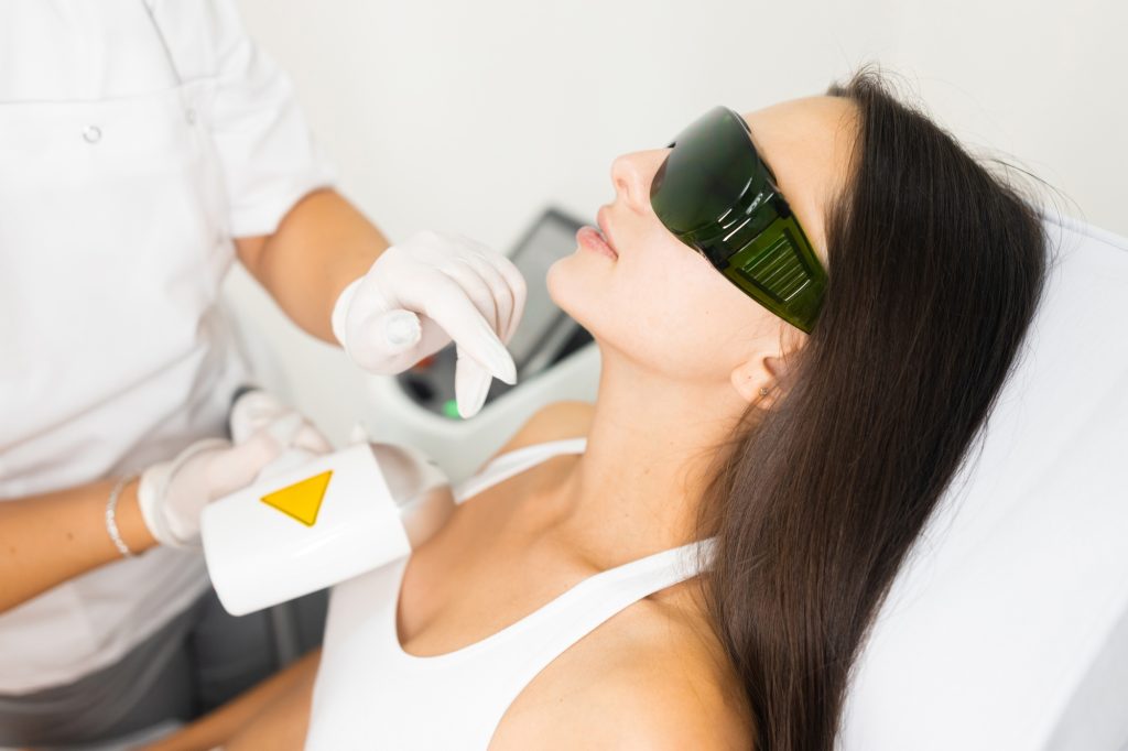 Laser hair removal for facial skin. Woman in epilation salon