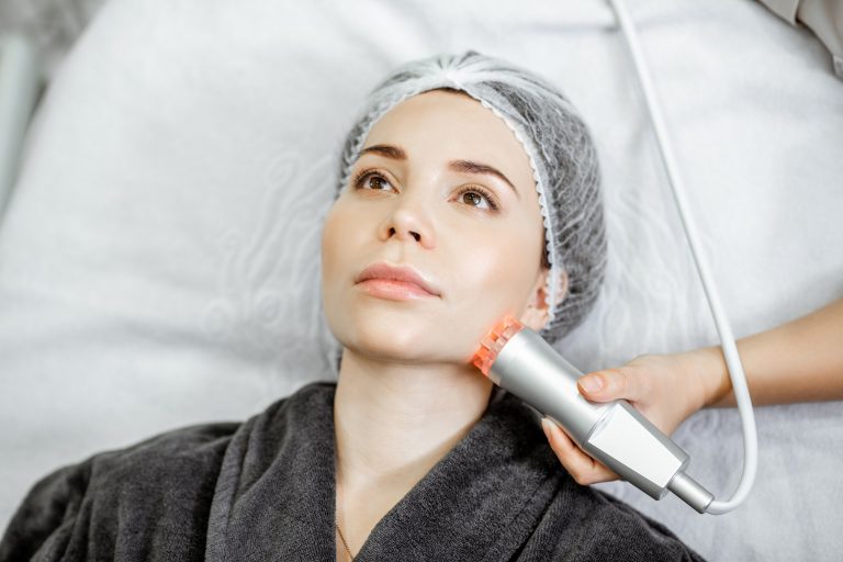 Woman during the facial treatment at the beauty salon