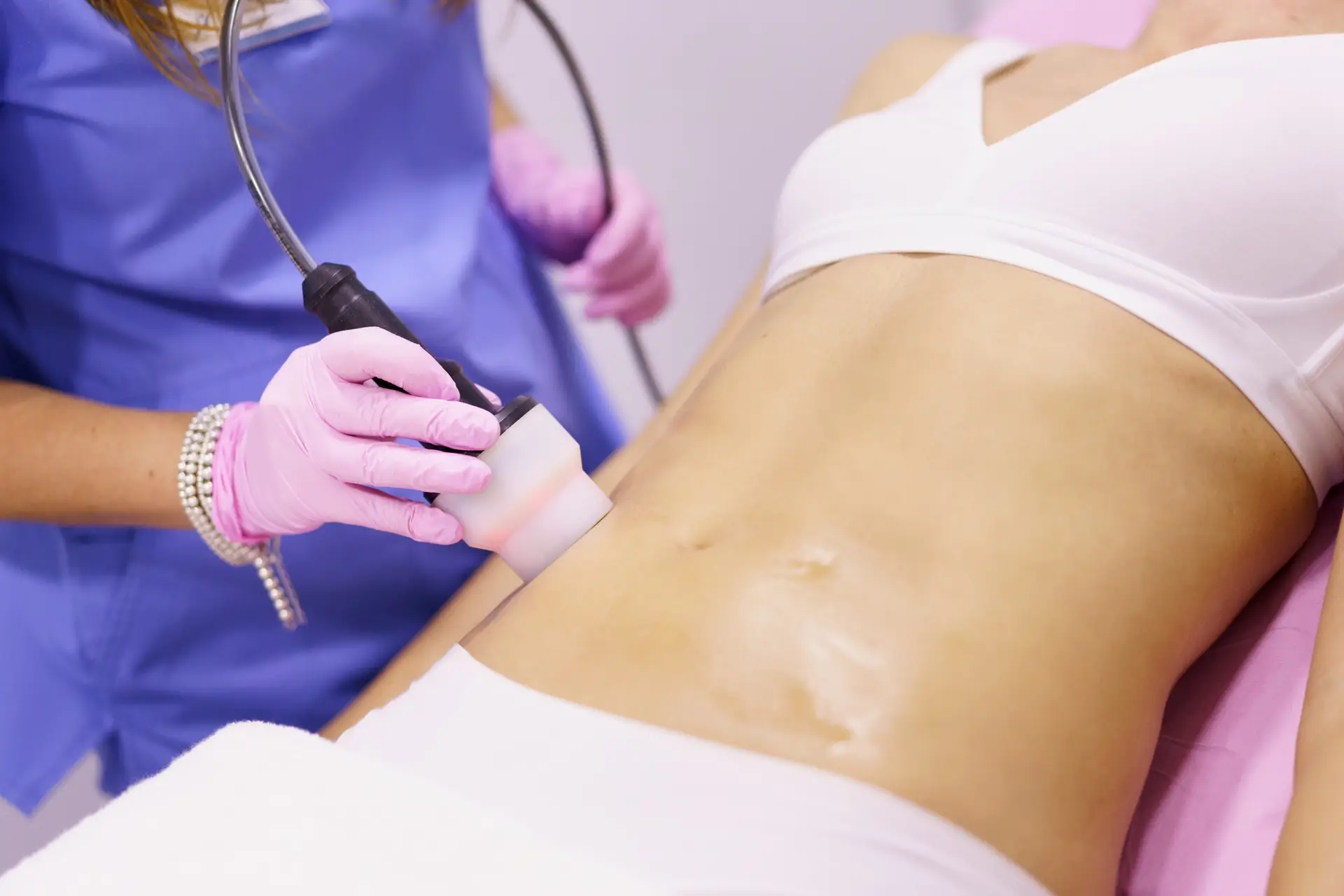Woman receiving anti-cellulite treatment with radiofrequency machine in a beauty center